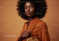 Elegant African Woman in Orange Satin Blouse with Gold Accessories