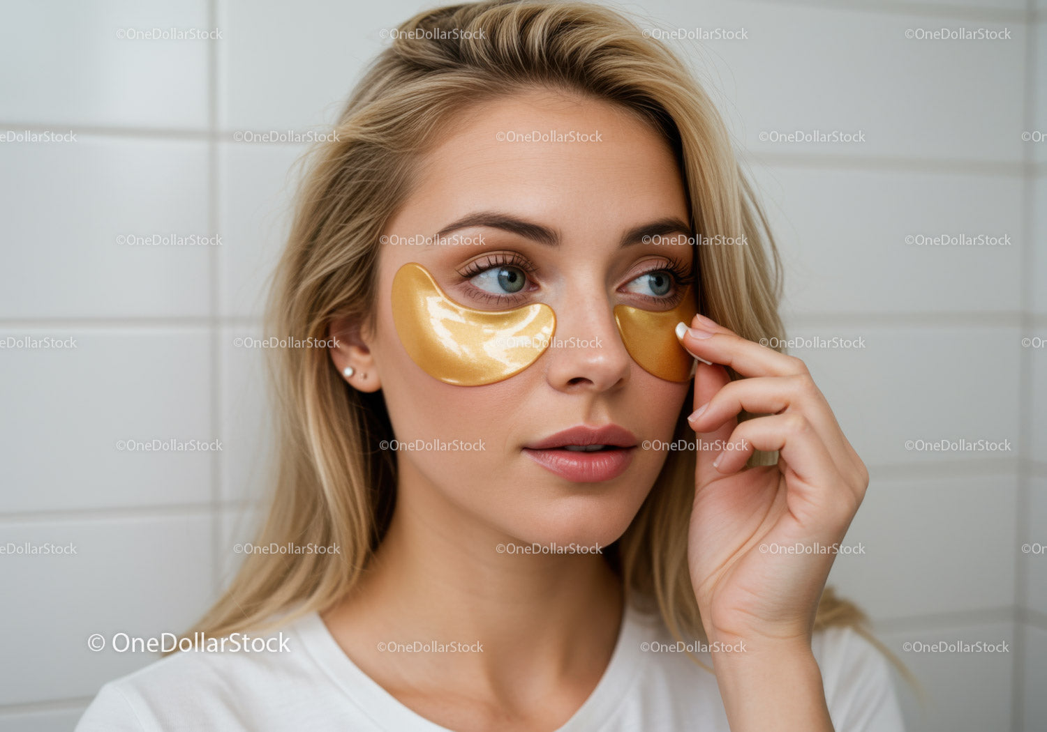 Young Woman Applying Gold Eye Masks for SkinRejuvenation