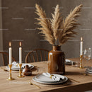 Elegant Dining Table Setup with White Crockery and Gold Accents