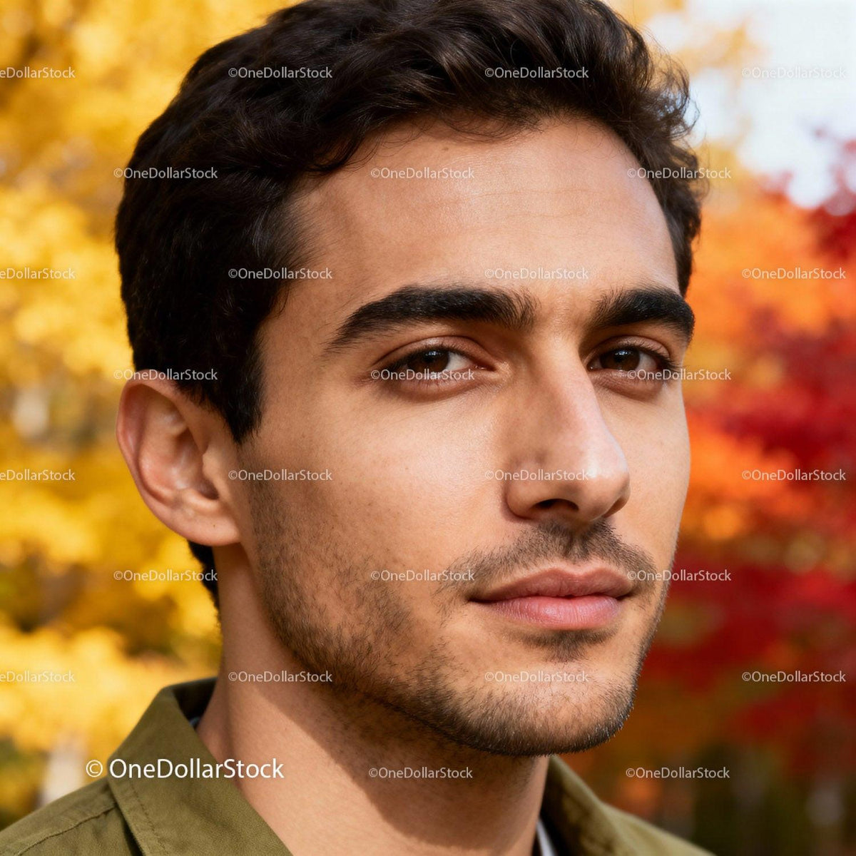 Young man with thoughtful expression in autumn park