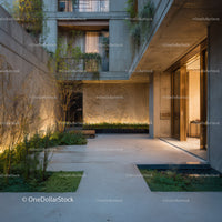 Modern Concrete Building with Lush Greenery and Ambient Lighting