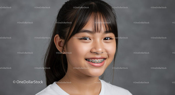 Young Asian Girl Smiling with Braces in Studio Portrait