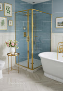Elegant bathroom with blue tile shower and freestanding tub