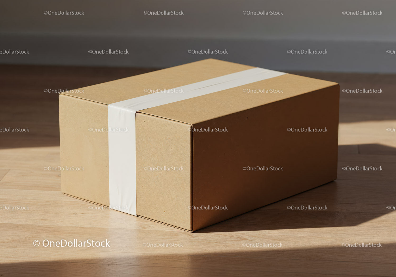 Simple cardboard box sealed with white tape on wooden floor