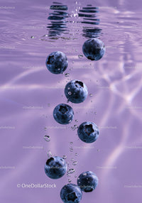 Fresh Blueberries Sinking in Clear Purple Water