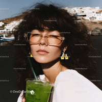 Stylish Woman Wearing Glasses Enjoying Green Cocktail on Sunny Beach