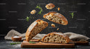 Fresh Rustic Bread with Rosemary Floating Above Wooden Board