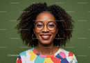 Confident Woman with Afro Hair Wearing Colorful Dress and Glasses
