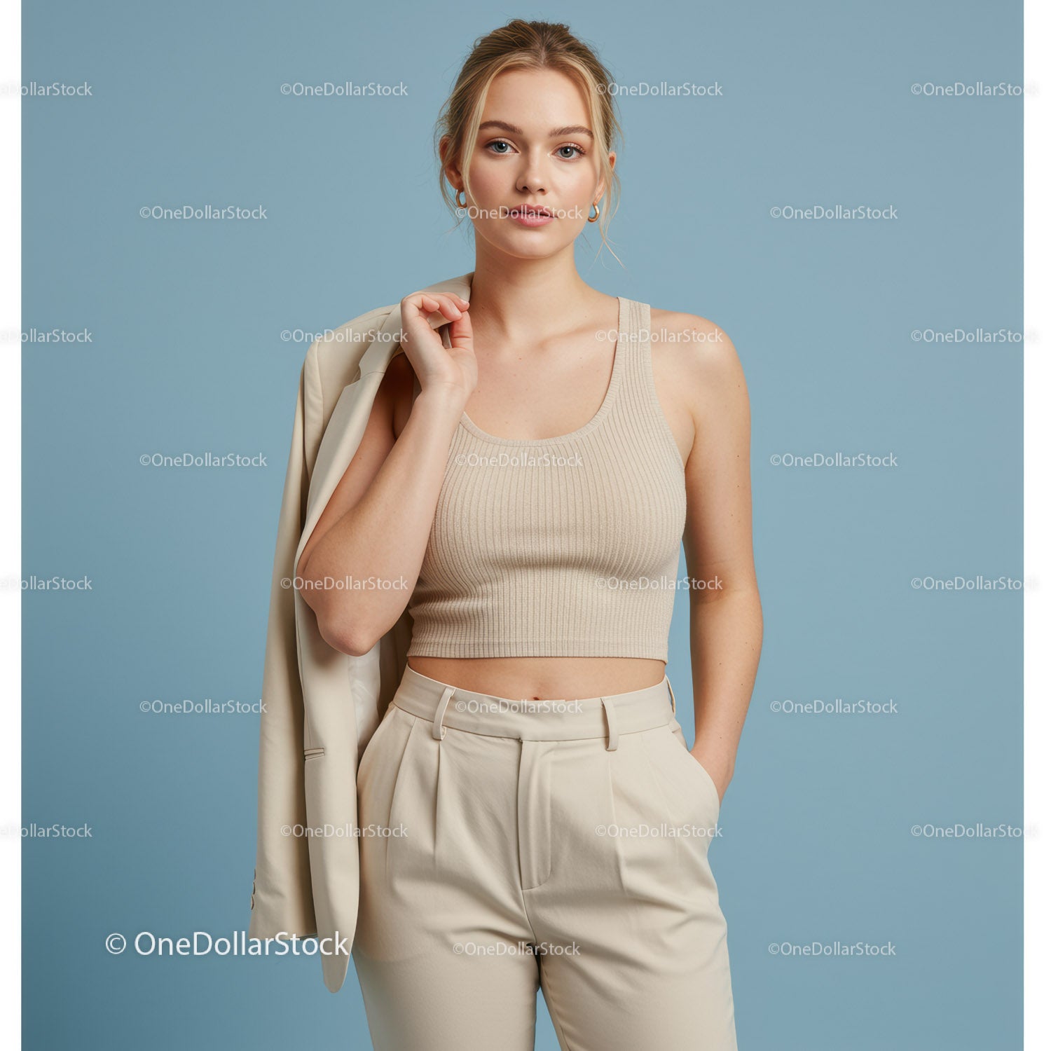Elegant Woman in Beige Crop Top and Pants on Pastel Background