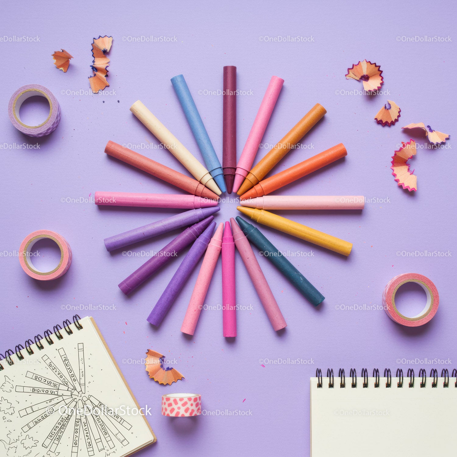 Colorful chalks arranged in circle on pastel background