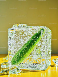 Fresh cucumber frozen inside a clear ice cube
