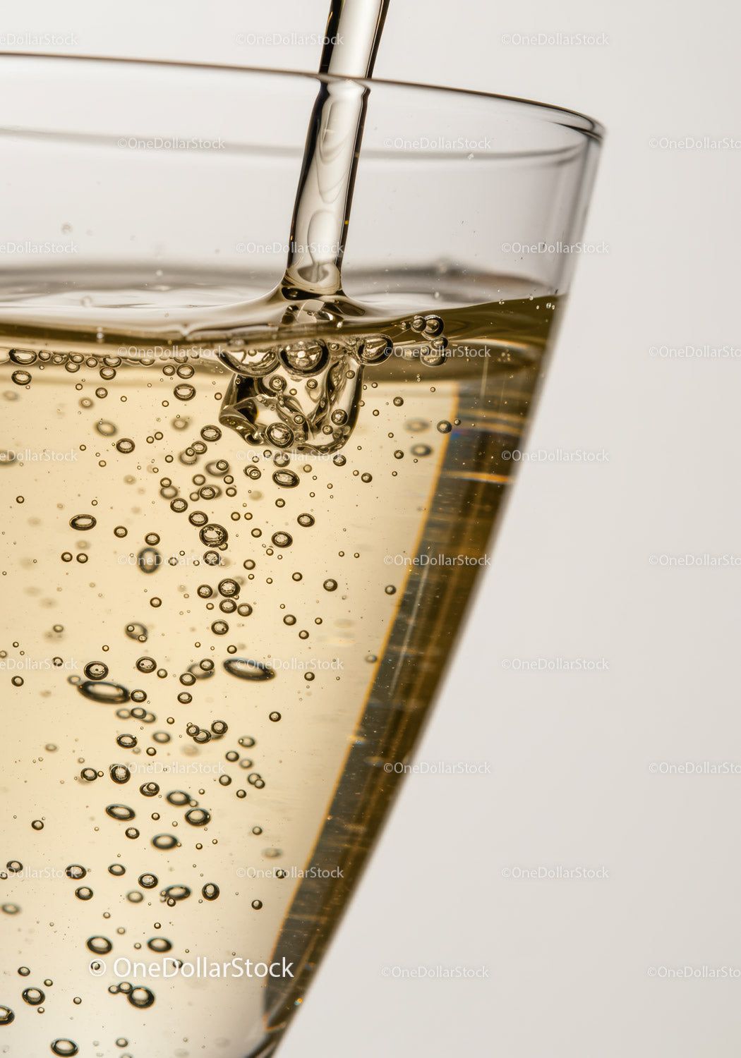 Close up of sparkling liquid pouring into glass