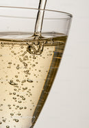 Close up of sparkling liquid pouring into glass