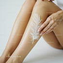 Close-Up of Human Legs with White Feather on Skin in Soft Natural Lighting
