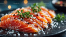 Fresh Sliced Smoked Salmon with Herbs and Sea Salt on Black Plate