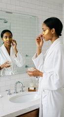 Elegant Woman Applying Facial Mask in Modern Bathroom