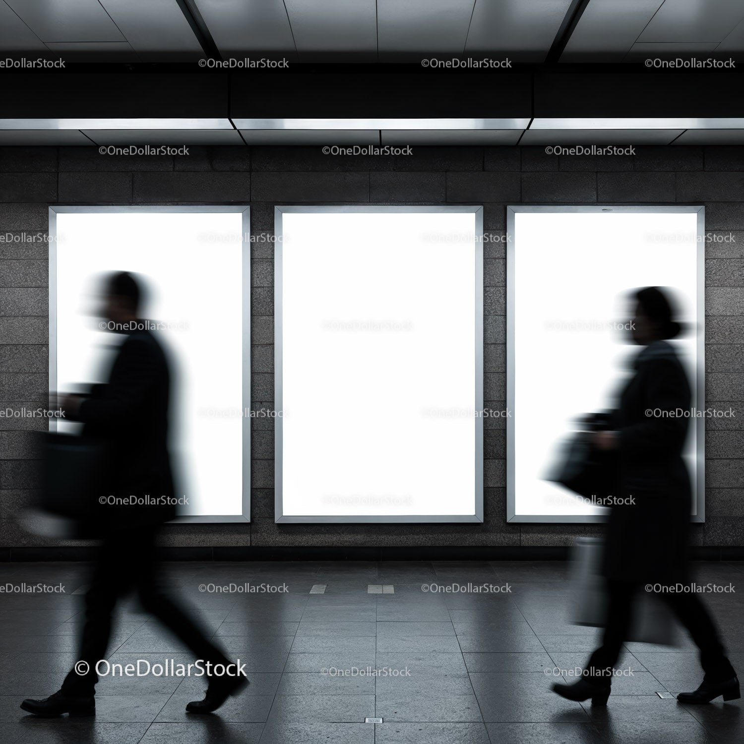 Blurred commuters walking past illuminated ad panels