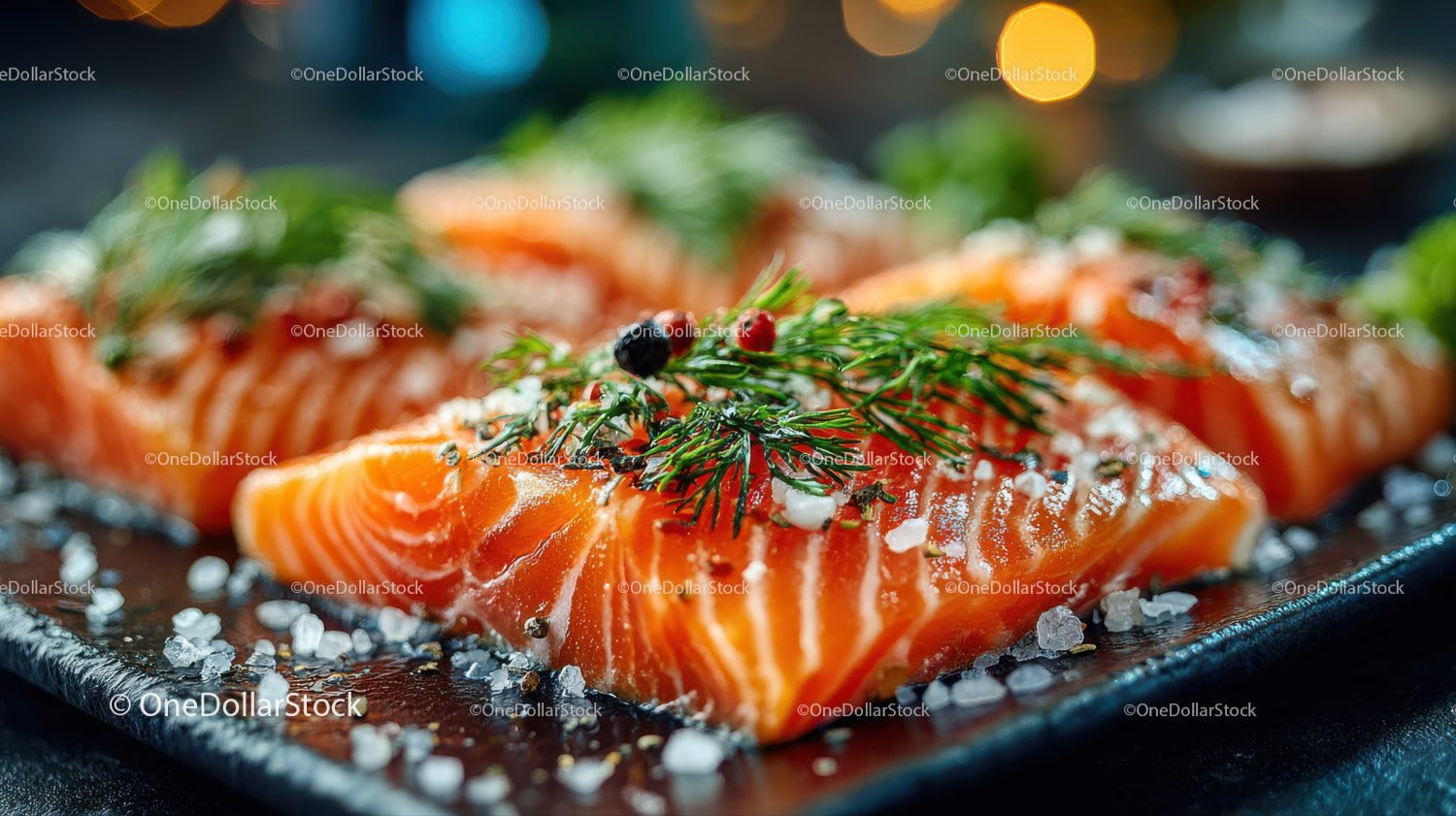Fresh Salmon Fillets Garnished with Dill and Salt on Black Slate