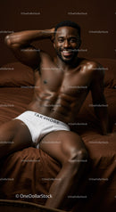 Relaxed shirtless man smiling on bed in white underwear