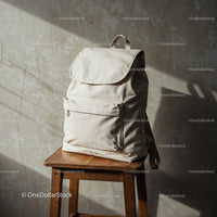 Minimalist beige backpack on wooden stool near wall
