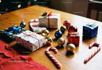 Festive Christmas gifts and ornaments on wooden table