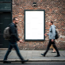 Blurred pedestrians walking past empty urban billboard
