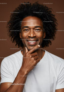 Smiling Black Man with Curly Hair Expressing Confidence in Studio