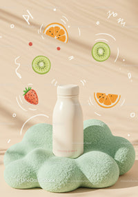 Milk bottle on soft green textured cushion with fruit