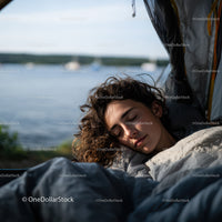 Calm Young Woman Sleeping Outdoors Near Lake in Tranquil Nature Setting