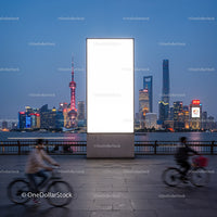 Evening Cityscape with Cyclists and Illuminated Billboard
