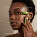 Elegant African Woman Using Jade Roller for Facial Skincare