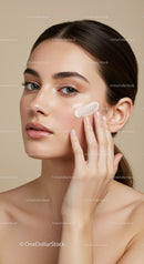 Young Woman Applying Moisturizer for Flawless Skin
