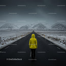 Lonely Traveler in Yellow Jacket on Snow-Covered Road
