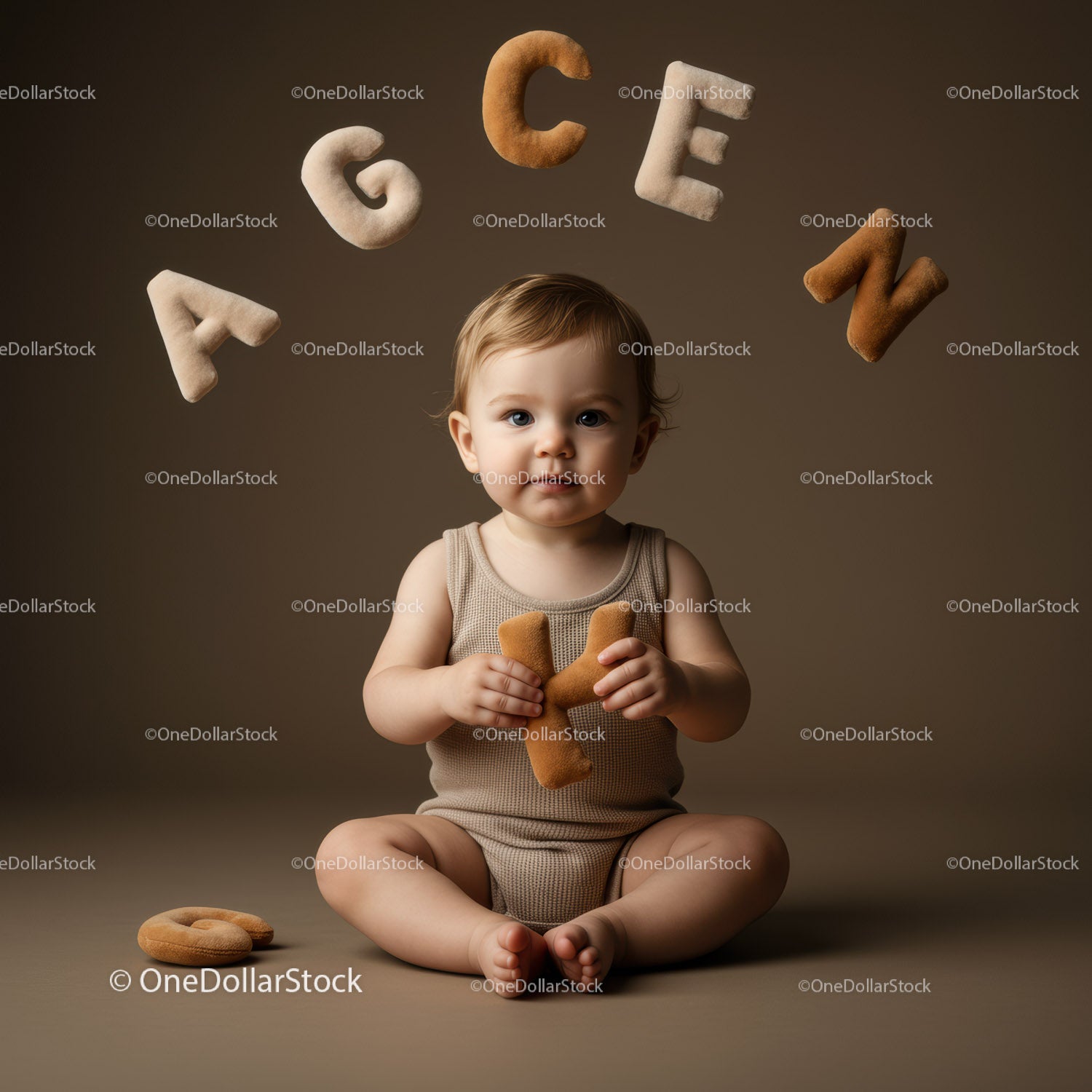Baby Playing with Alphabet Plush Letters on Brown Background