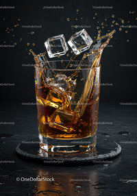 Refreshing whiskey splash with ice cubes in glass