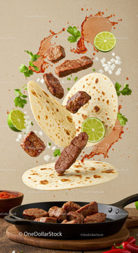 Juicy steak pieces with tortillas and fresh lime slices