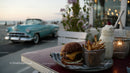 Beachside Casual Outdoor Dining Scene with Burger Fries and Milkshake