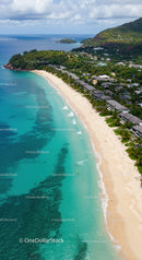 Tropical Beach with Overwater Bungalows and Mountain Backdrop