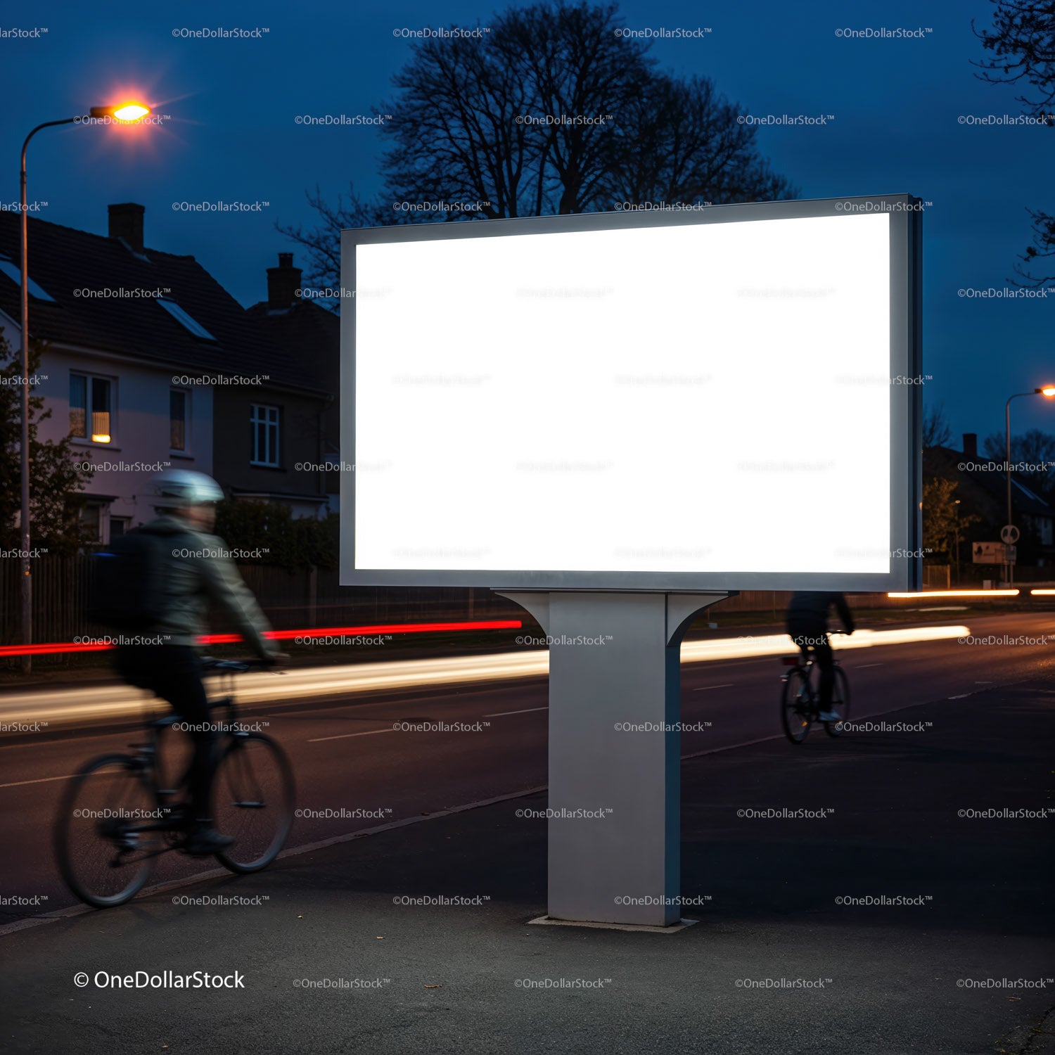 Blank illuminated billboard on urban street at dusk