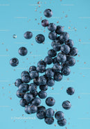 Fresh blueberries submerged in clear water splash