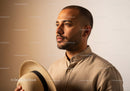 Portrait of a Stylish Man with Straw Hat in Modern Fashion Setting