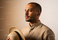 Portrait of a Stylish Man with Straw Hat in Modern Fashion Setting