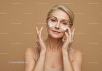 Woman Applying Facial Cream with Skincare Routine Concept