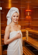 Relaxing Woman in Towel at Sauna with Wooden Interior