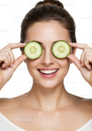 Smiling Woman with Cucumber Slices Covering Eyes for Skin Care