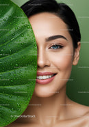 Close-up of a Smiling Woman with Blue Eyes and Green Leaf