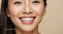 Close up of smiling young woman with healthy skin