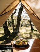 Steaming pasta dish with mushrooms in peaceful forest camp