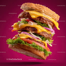 Layered Cheeseburger with Lettuce Tomato Onions and Bacon