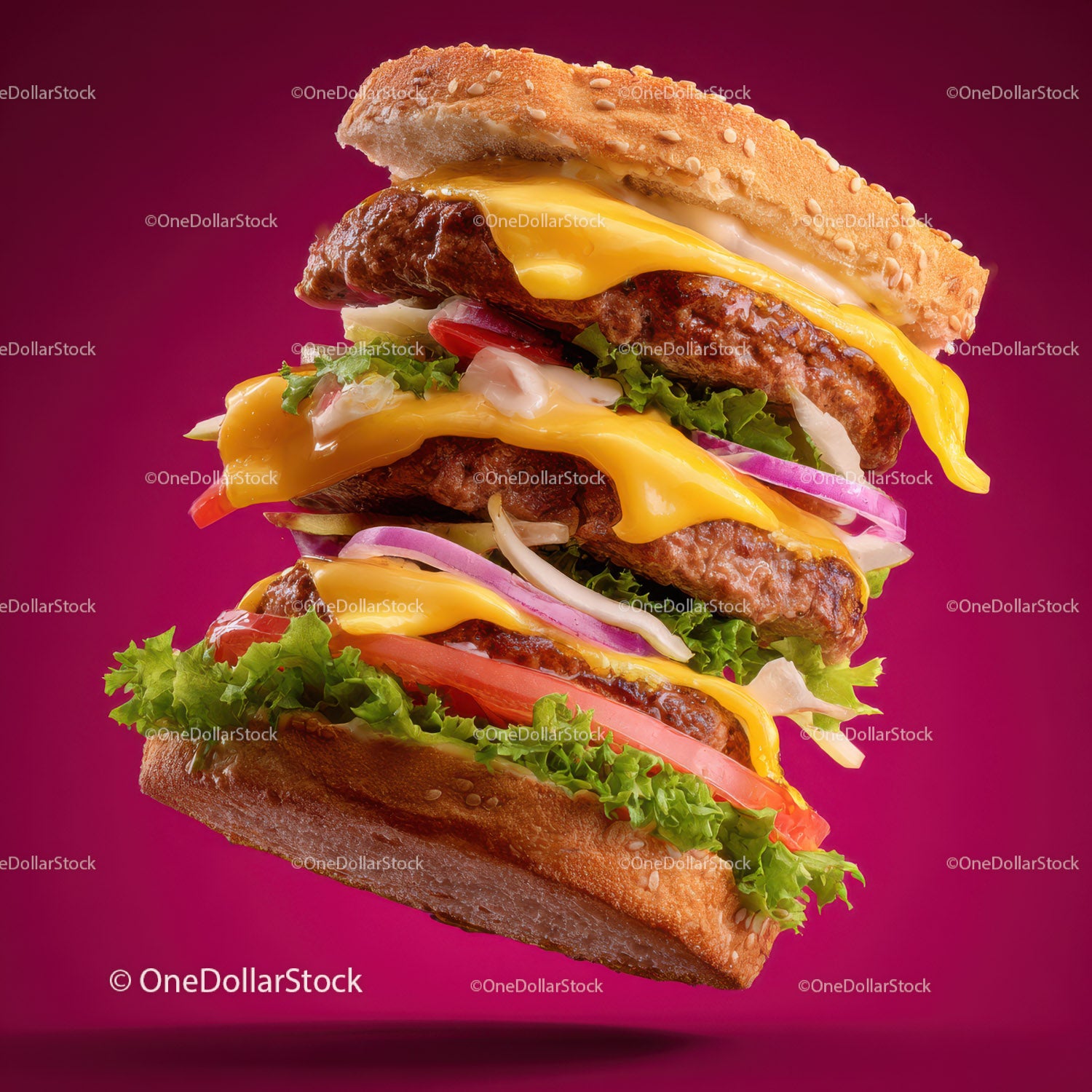 Layered Cheeseburger with Lettuce Tomato Onions and Bacon